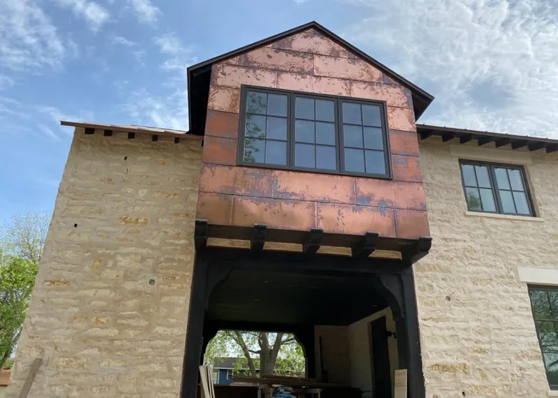 Copper metal panel facade on a stone building for Roof Repair in Ocean Springs